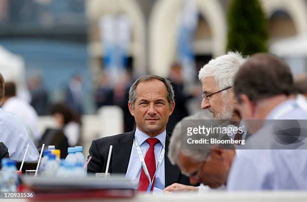 Frederic Oudea, chief executive officer of Societe Generale SA, center, talks with colleagues at an outdoor terrace on the opening day of the St....