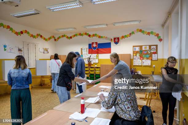 Voters wait in line to cast their ballots at a polling station in Slovak parliamentary elections on September 30, 2023 in Bratislava, Slovakia. The...