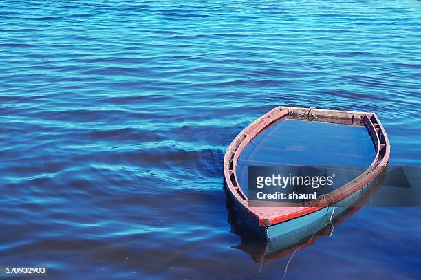 sunken rowboat - sinking rowboat stock pictures, royalty-free photos & images