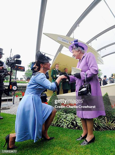 Queen Elizabeth II is congratulated by Princess Haya bint Al Hussein on Ladies' Day during day three of Royal Ascot at Ascot Racecourse on June 20,...