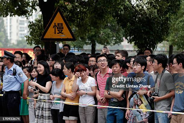 Fans wait outside the cordon during David Beckham's visit at Tongji University on June 20, 2013 in Shanghai, China.