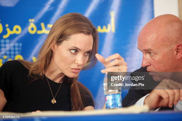 Actress and UNHCR Special Envoy Angelina Jolie listens to Andrew Harper the UNHCR representative in Jordan, as she holds a press conference with the...
