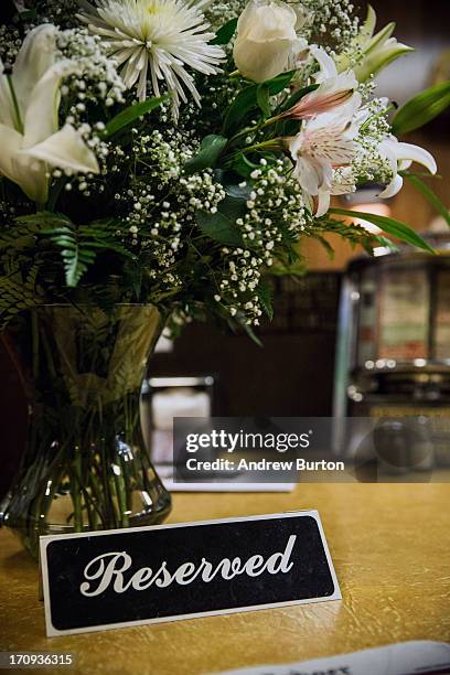 Flowers and a 'Reserved' sign sit at the booth where the final scene of the final episode of the HBO show, "The Sopranos," was filmed, at Holsten's...