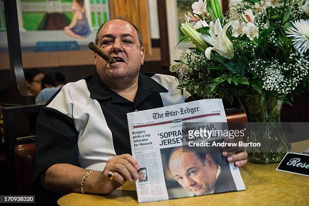 Donald Metzger, a James Gandolfini and Tony Soprano impersonator, poses for a photo at the booth where the final scene of the final episode of the...