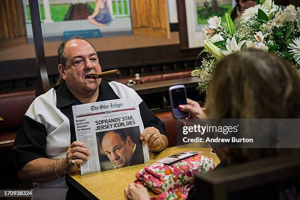 Donald Metzger, a James Gandolfini and Tony Soprano impersonator, poses for photos at the booth where the final scene of the final episode of the HBO...