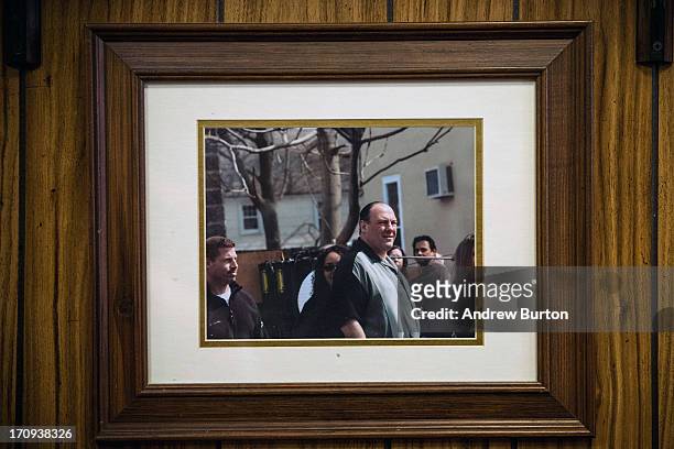Photo of James Gandolfini playing the character Tony Sopranos, while on set of the HBO show, "The Sopranos," hangs on the wall at Holsten's, the...