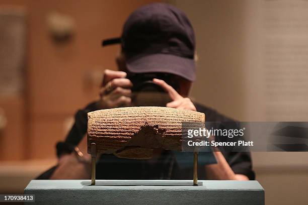 The Cyrus Cylinder-a 2,600-year-old inscribed clay document from Babylon in ancient Iraq-is viewed at the The Metropolitan Museum of Art on June 20,...