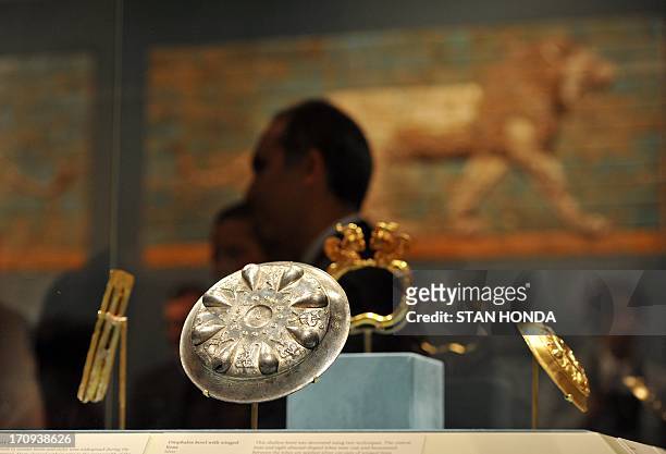Silver Omphalos bowl with winged lions from the Persian Empire on display with other items in "The Cyrus Cylinder and Ancient Persia: Charting a New...