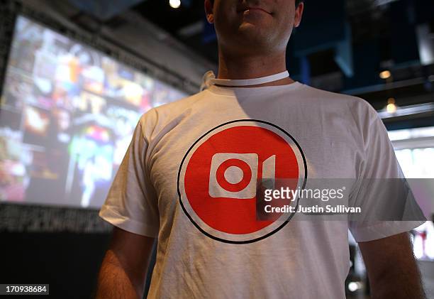 Facebook employee wears a shirt with the logo of the new Instagram video option during a press event at Facebook headquarters on June 20, 2013 in...