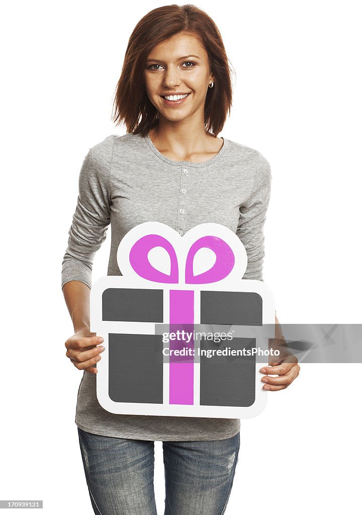 Smiling young woman holding gift sign isolated on white background.