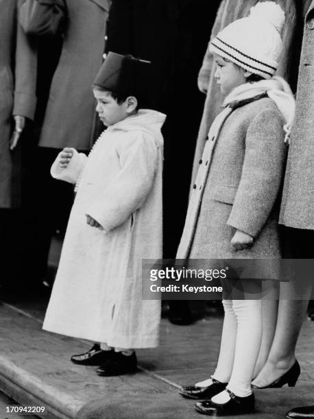 Crown Prince Sidi Mohammed and his sister Princess Lalla Meryem on the north portico of the White House as their father, King Hassan II of Morocco is...