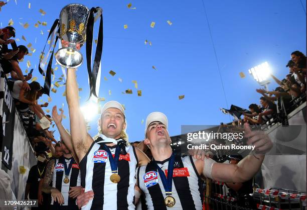 Darcy Moore of the Magpies and Brayden Maynard of the Magpies celebrate winning with the AFL Premiership Cup during the 2023 AFL Grand Final match...