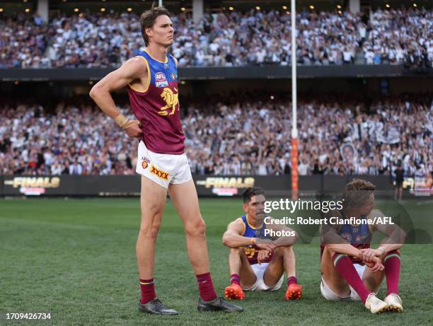 Eric Hipwood, Charlie Cameron and Joe Daniher of the Lions are dejected after the Lions were defeated by the Magpies during the 2023 AFL Grand Final...