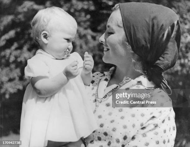 Princess Paola of Belgium smiles at her baby daughter, Princess Astrid of Belgium, in the gardens of the Chateau de Belvedere, Brussels, 4th June...