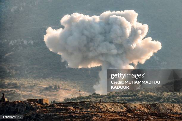 Plume of smoke rises above hills near the city of Jisr ash-Shughur, in the rebel-held northwestern Idlib governorate, during bombardment by pro...