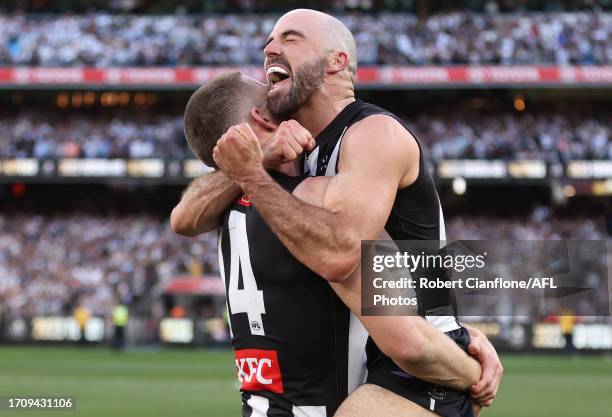 Darcy Cameron and Steele Sidebottom of the Magpies celebrate after the Magpies defeated the Lions during the 2023 AFL Grand Final match between...