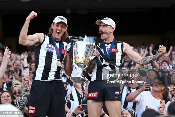 Nathan Murphy of the Magpies and Oleg Markov of the Magpies celebrates winning with the AFL Premiership Cup during the 2023 AFL Grand Final match...