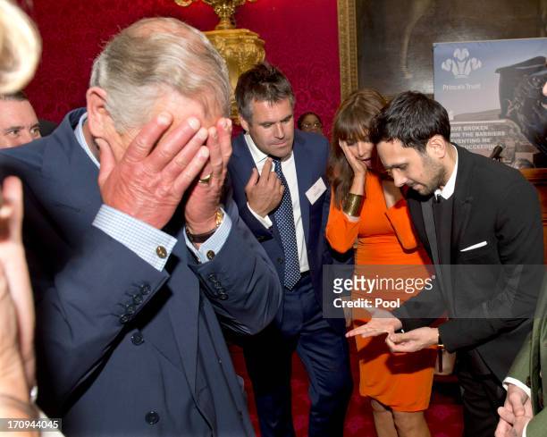 Prince Charles, Prince of Wales reacts as magician Dynamo demonstrates the flexibility of his fingers as Kenny Logan and Carol Voderman look on at a...