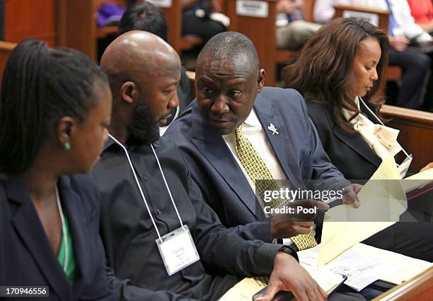 Benjamin Crump, family attorney for Trayvon Martin's parents, Tracy Martin and Sybrina Fulton goes over the potential jury list with them during...