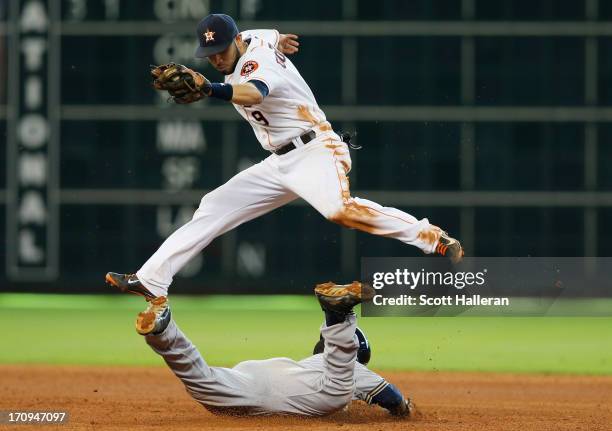 Jean Segura of the Milwaukee Brewers slides safely into second base in the seventh inning under the tag of Marwin Gonzalez of the Houston Astros at...