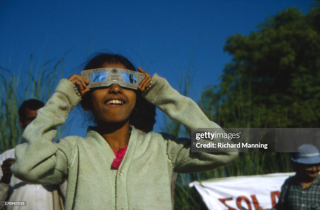 Girl Viewing A Solar Eclipse