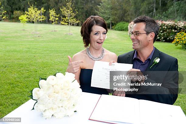 bride & groom with wedding certificate - marriage certificate stock pictures, royalty-free photos & images