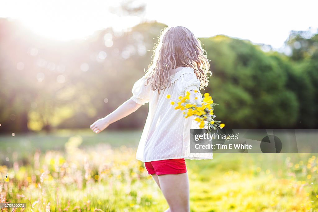 Woman in meadow at sunset