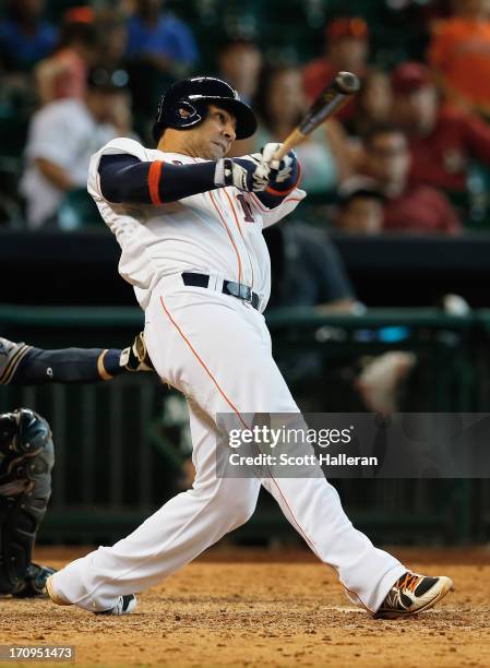 Carlos Pena of the Houston Astros watches his three-run home run in the tenth inning to defeat the Milwaukee Brewers 7-4 at Minute Maid Park on June...