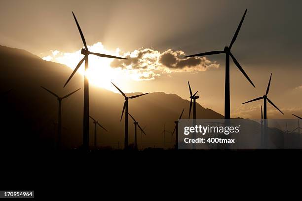silhouetted wind turbine farm - wind turbine california stock pictures, royalty-free photos & images