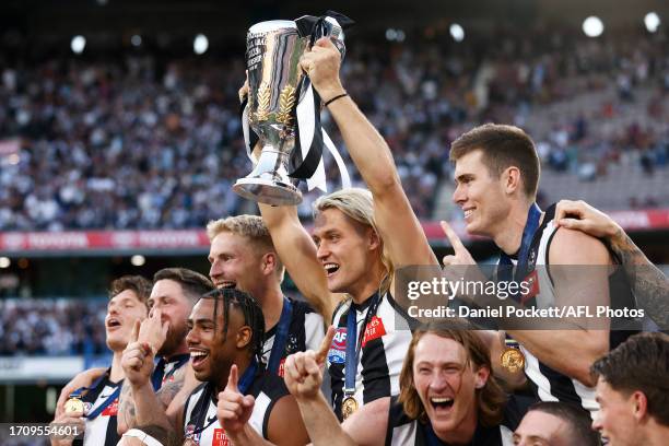 Darcy Moore of the Magpies holds aloft the 2023 AFL Premiership Cup after winning the 2023 AFL Grand Final match between Collingwood Magpies and...