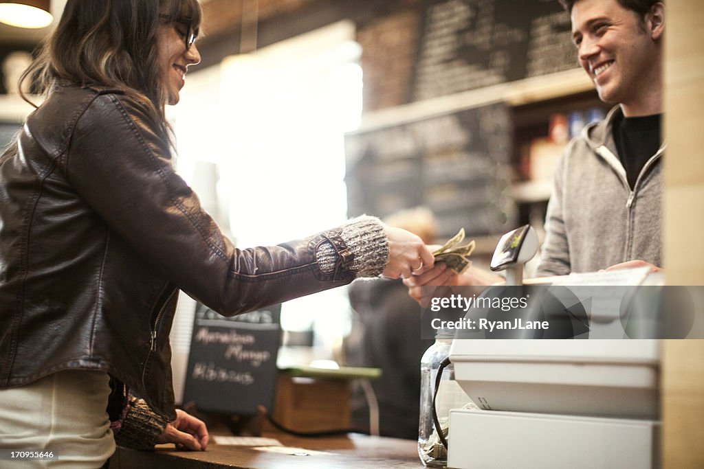 Young woman purchasing coffee