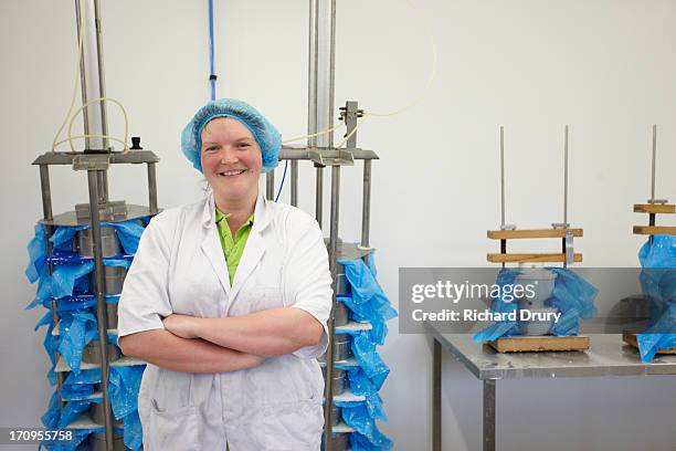 worker in goats cheese production unit - dairy products stock pictures, royalty-free photos & images