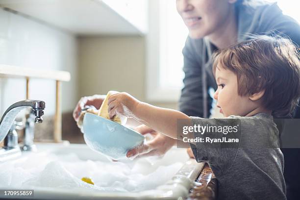 baby dish washing - dirty dishes stockfoto's en -beelden