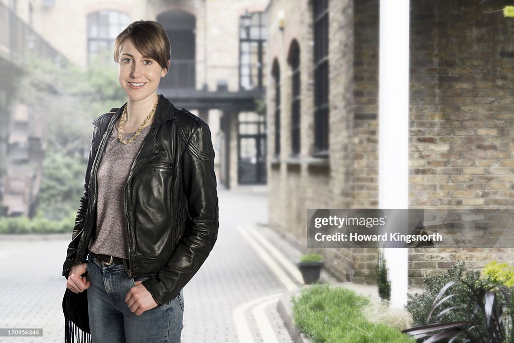 Female standing in street,smiling to camera