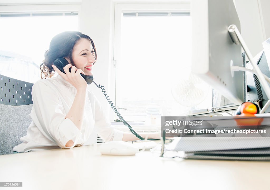 Female office working on telephone