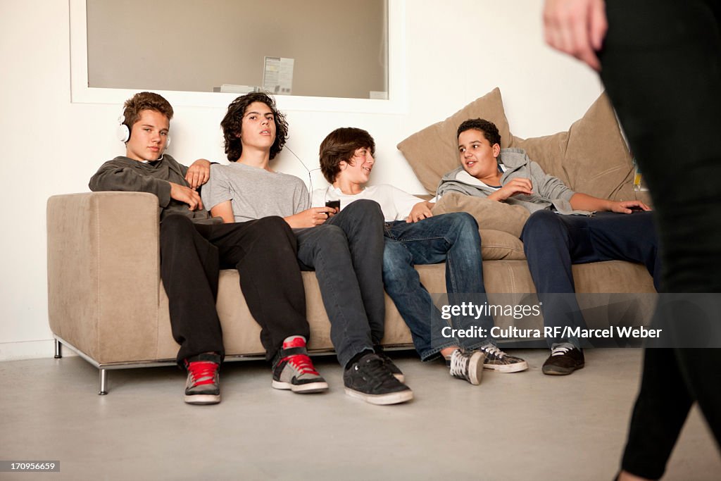 Teenage boys sitting on sofa