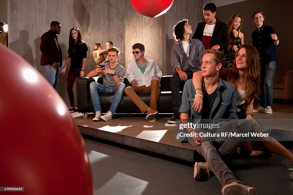 Couple in nightclub teenage girl with arm around teenage boy