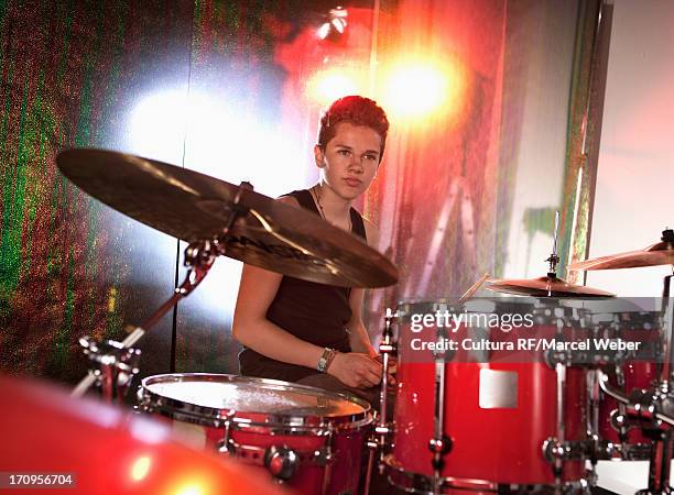 teenage boy playing drum kit - creative rf stock-fotos und bilder