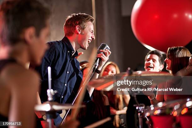 young man singing in band - creative rf stock-fotos und bilder