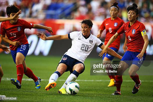 Abby Wambach of the USA scores her 157th International goal against Kim Narae and Shim Seoyeon of Korea Republic during the first half of their game...