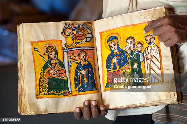 priest is showing an ancient book in ethiopia - ethiopia bildbanksfoton och bilder