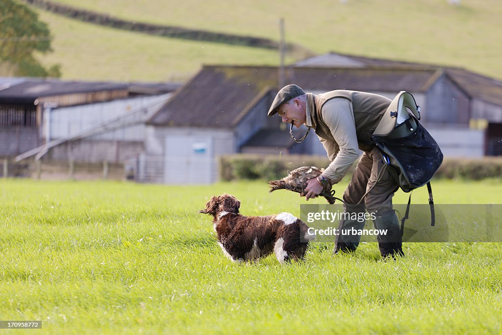 Gamekeeper praising his dog