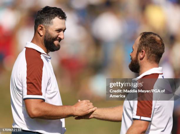 Tyrrell Hatton and Jon Rahm of Team Europe shake hands on the 17th green after winning their match 2&1 during the Saturday morning foursomes matches...