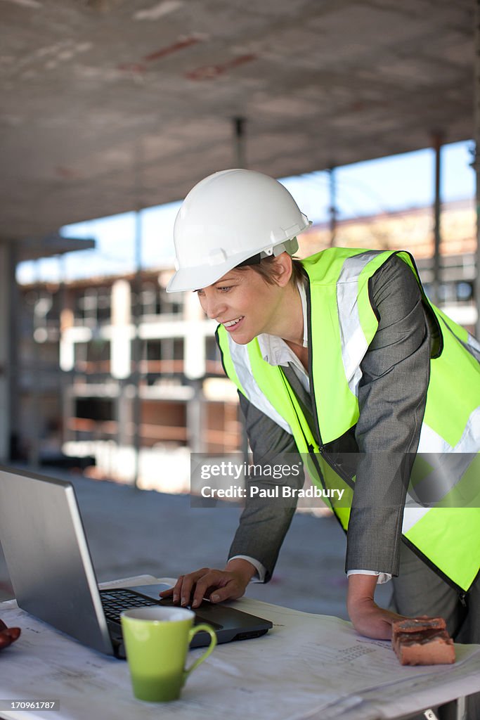 Construction worker using laptop on construction site