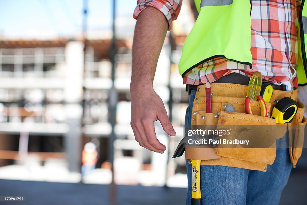 Close up of construction workers tool belt on construction site