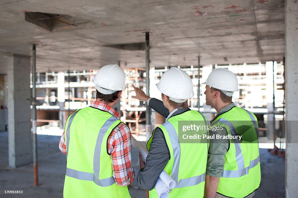 Construction workers talking on construction site