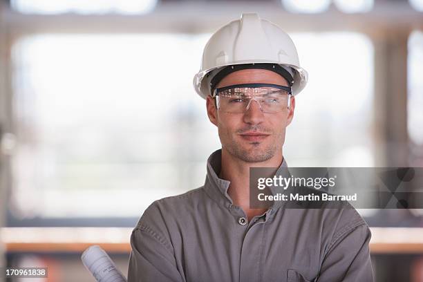 construction worker on construction site - protective headwear stock pictures, royalty-free photos & images