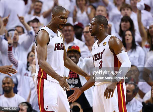 Chris Bosh and Dwyane Wade of the Miami Heat celebrate in the second quarter while taking on the San Antonio Spurs during Game Seven of the 2013 NBA...