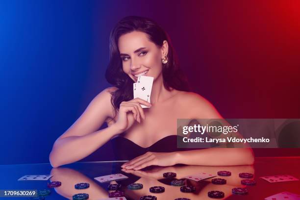 portrait of young lady professional poker player spend evening night at poker club hold cards two aces win big money - poker dealer stock pictures, royalty-free photos & images