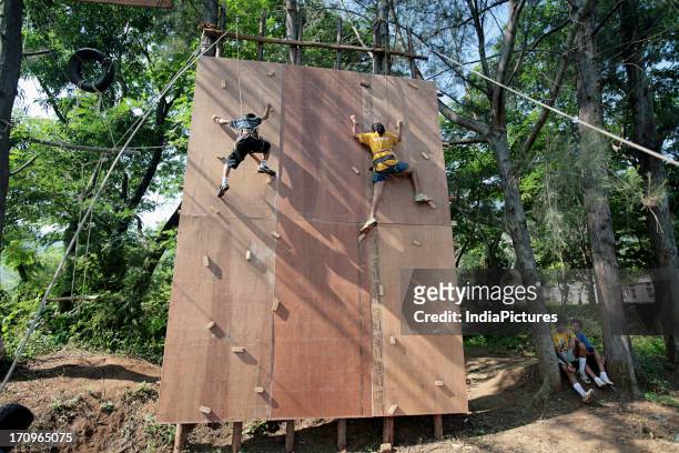 Kids climbing an artificial wall during an adventure workshop.